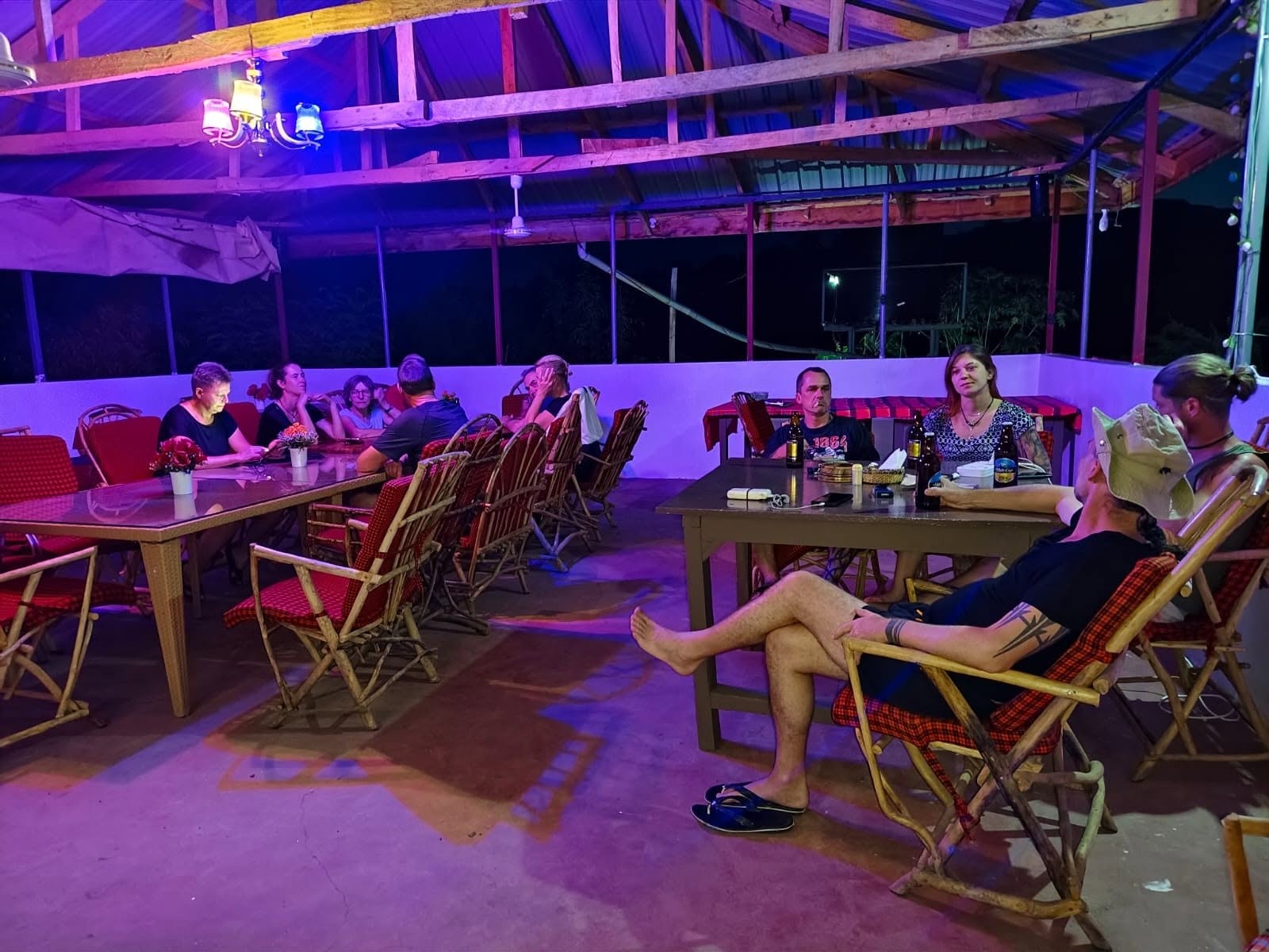 Guests dining at the rooftop restaurant at night, under string lights